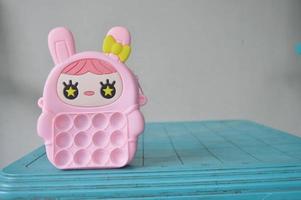pop it childrens toys combined into a small bag. cute pink object. photo