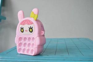pop it childrens toys combined into a small bag. cute pink object. photo