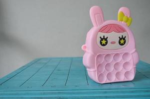 pop it childrens toys combined into a small bag. cute pink object. photo