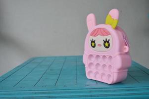 pop it childrens toys combined into a small bag. cute pink object. photo