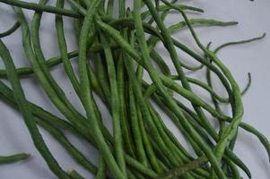 string beans on a white background. food material. source of vitamins. food menu for iftar. photo