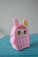 pop it childrens toys combined into a small bag. cute pink object. photo
