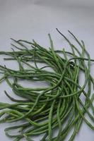 string beans on a white background. food material. source of vitamins. food menu for iftar. photo