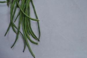 green beans on a white background. food material. source of vitamins. food menu for iftar. photo