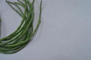 green beans on a white background. food material. source of vitamins. food menu for iftar. photo