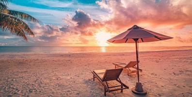 Stunning beach. Chairs umbrella under palm leaves. Summer beach holiday, couple vacation tourism destination. Romantic tropical landscape. Tranquil panoramic beach, tropical landscape banner photo