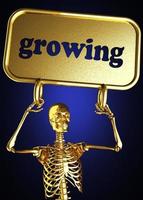 palabra en crecimiento y esqueleto dorado foto