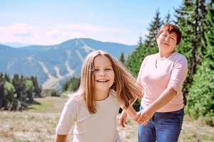 family grandmother and mother in mountains happy to travel. Leisure family time, summer concept photo