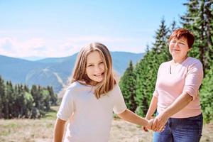 family grandmother and mother in mountains happy to travel. Leisure family time, summer concept photo