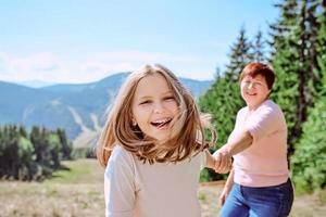 family grandmother and mother in mountains happy to travel. Leisure family time, summer concept photo