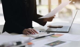 Close up view of bookkeeper or financial inspector hands making report, calculating or checking balance. Home finances, investment, economy, saving money or insurance concept photo