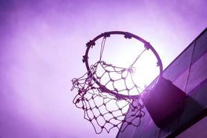 Wooden basketball hoop during sunset. photo