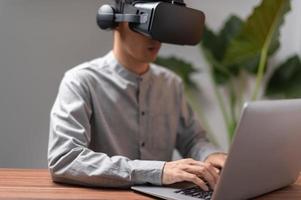 People are using notebook computers to communicate, work, play games, watch movies through VR glasses. photo