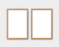 Set of 2 vertical wooden frames mockup with a border hanging on the wall. Empty base for picture or text. 3D rendering. photo