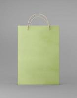 Eco packaging mockup bag kraft paper with handle front side. Standart medium green template on gray background promotional advertising. 3D rendering photo