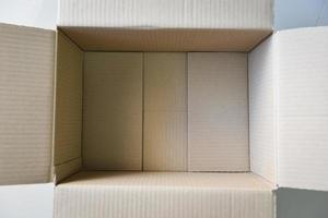 Open cardboard box on floor background High angle view of an empty cardboard box or Parcel box photo