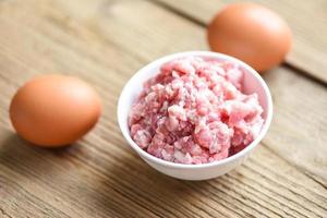 Mincemeat , minced or ground meat Raw pork on bowl with egg  , Ground Pork. photo