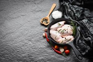 Raw chicken wings, herbs and spices with pepper chili tomato garlic for cooking, rosemary chicken. photo