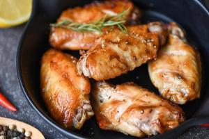 Baked chicken wings with sauce and herbs and spices cooking thai asian food rosemary chicken grilled. photo