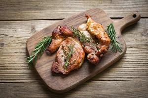 grilled pork meat with sauce and herbs and spices cooking thai asian food rosemary pork on chopping board. photo