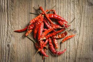 Dried chili on wooden background - Red dried chilli pepper cayenne foe cooked asian picy food photo