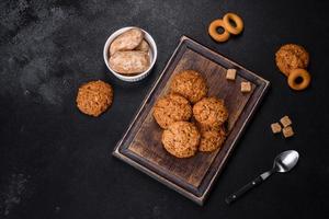 Tasty fresh oat cookies on a dark concrete background photo