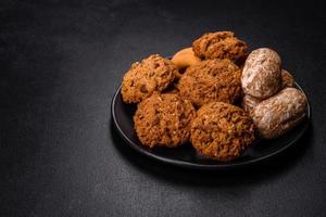 Tasty fresh oat cookies on a dark concrete background photo