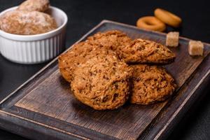 Tasty fresh oat cookies on a dark concrete background photo