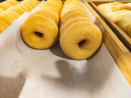 Closeup of tasty donuts in old wooden boxes photo