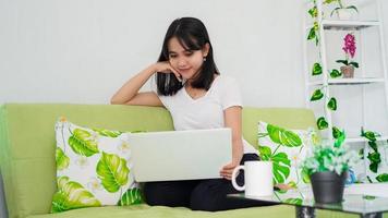 asian women sitting on chair work from home at laptop and thinking of problem solution photo