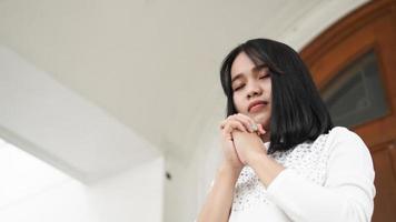 a Christian woman praying humbly in church photo