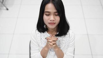 a Christian woman praying humbly in church photo