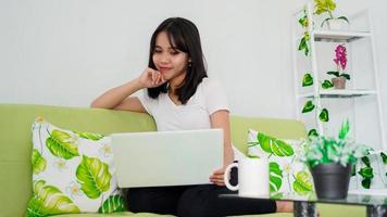 asian women sitting on chair work from home at laptop and thinking of problem solution photo