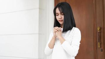 a Christian woman praying humbly in church photo