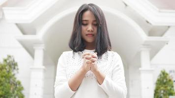 a Christian woman praying humbly in church photo