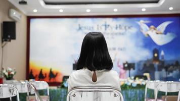 a Christian woman praying humbly in church photo