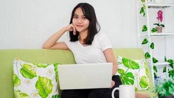 asian women sitting on chair work from home at laptop and thinking of problem solution photo