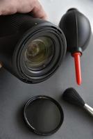 Cleaning photo lenses with a brush and a pear