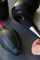 Cleaning photo lenses with a brush and a pear