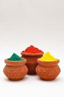 Indian festival Holi concept  bowl with colors of holi on white background. photo