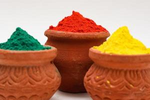 Indian festival Holi concept  bowl with colors of holi on white background. photo