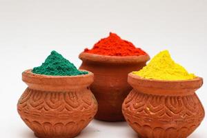 Indian festival Holi concept  bowl with colors of holi on white background. photo