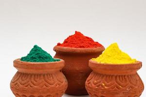 bowl with colors of holi on white background. photo