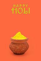 Indian festival Holi concept Multi color's bowl with colorful background and writing happy holi photo
