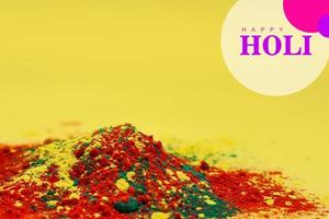 Indian festival Holi concept Multi color's bowl with colorful background and writing happy holi photo