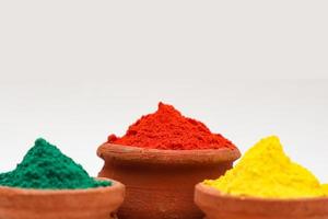 Indian festival Holi concept Multi color's bowl with colorful background. photo