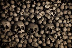 Watercolor drawing of Human bones and skulls. Row of skulls. Skulls collection. Symbol of death, fear and evil photo