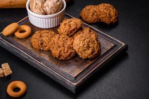 Tasty fresh oat cookies on a dark concrete background photo