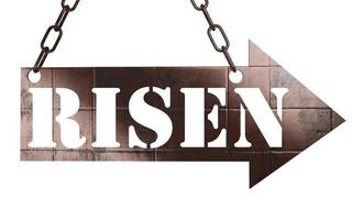 risen word on metal pointer photo