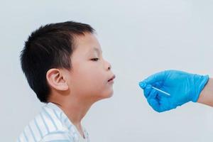 A nurse is using an initial virus test kit for her son, the Antigen Test Kit, or ATK, as a test kit for COVID-19. photo